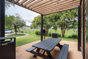 Picnic table under a wooden canopy at Grand Villas at Cinco Ranch, Katy, Texas